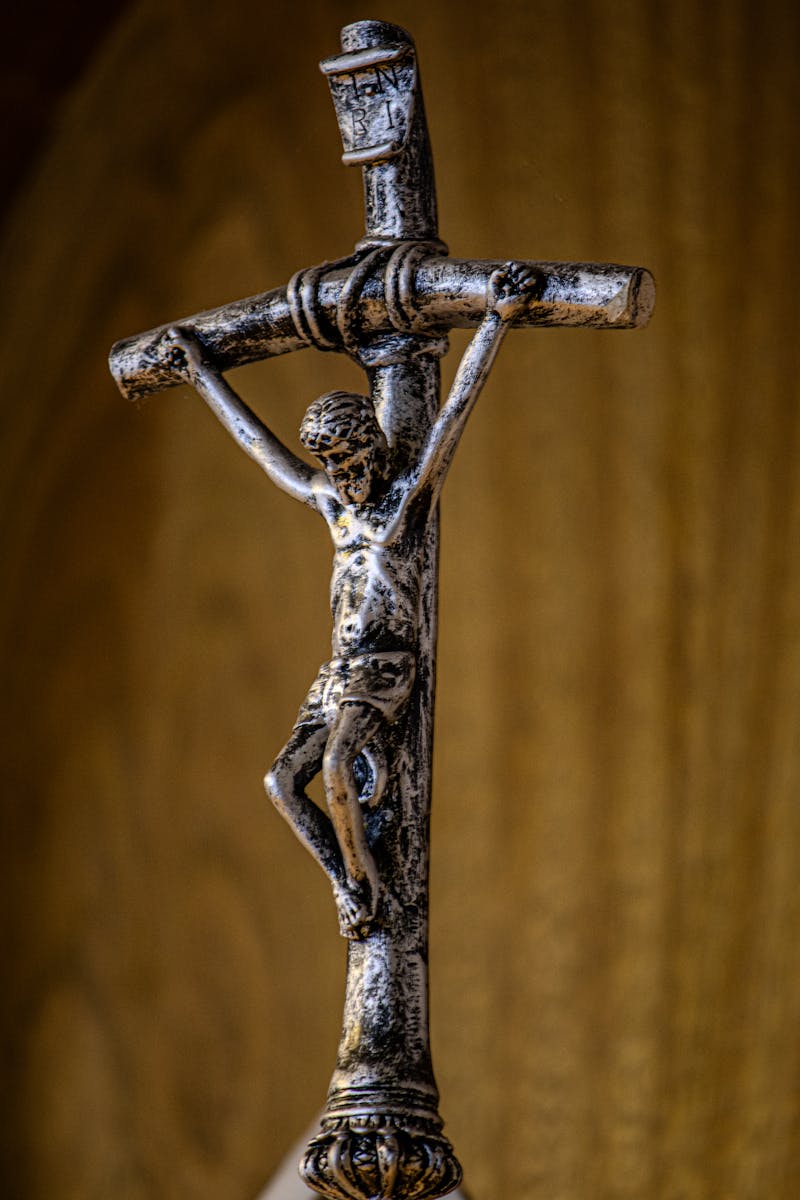 A detailed silver crucifix depicting Jesus Christ, highlighting Christian symbolism and faith.