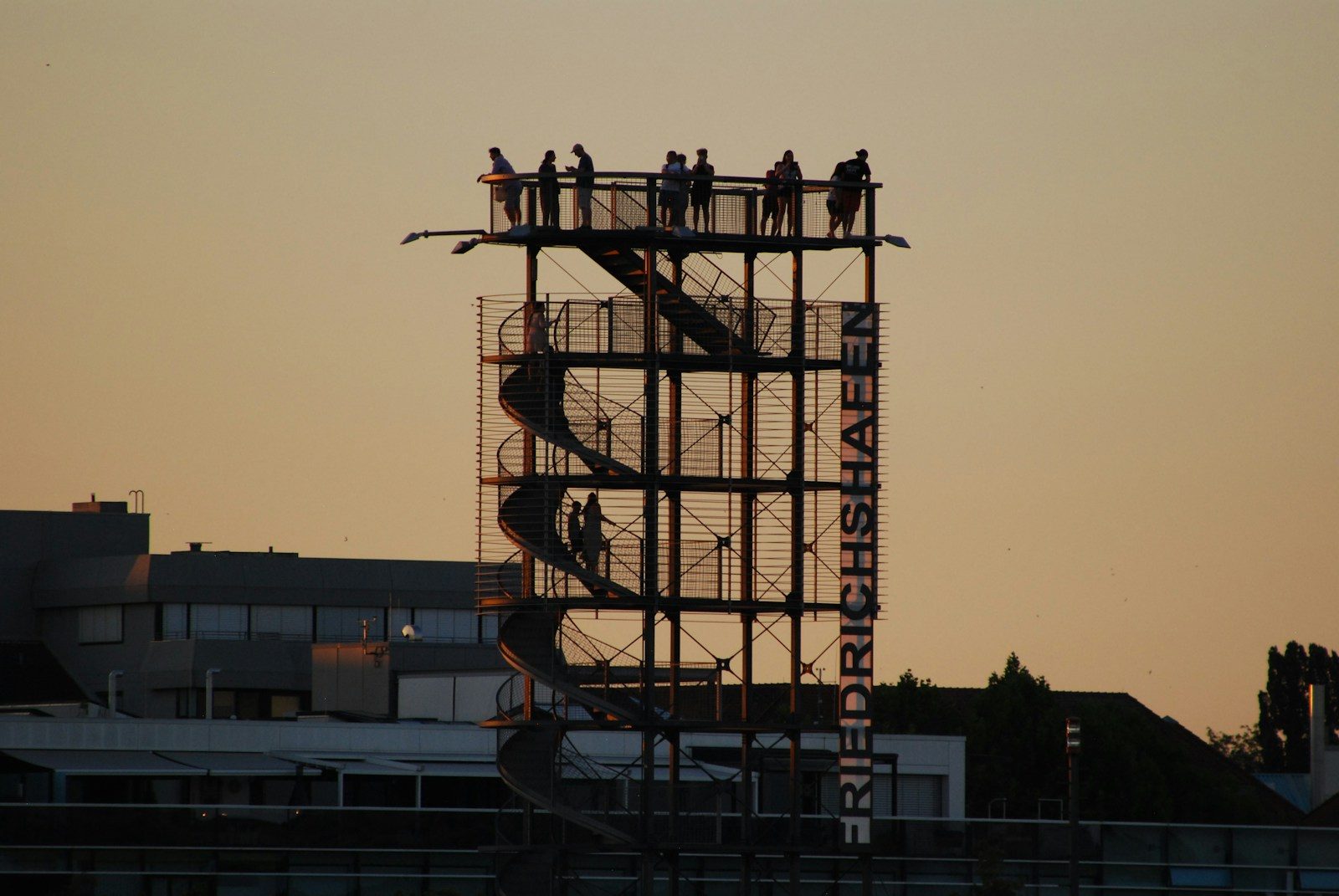 People on a tall observation tower at sunset